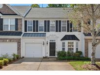 Charming two-story townhouse with a well-maintained front yard and attached garage at 831 Daly Cir, Fort Mill, SC 29715