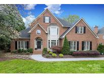 Charming two-story brick home with a well-manicured lawn and inviting front entrance at 10524 Hadleigh Pl, Charlotte, NC 28210