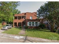 Two-story brick home featuring a covered porch and a well-maintained front yard at 1205 W Bank St, Salisbury, NC 28144