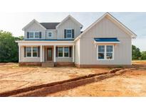 Charming two-story home featuring a welcoming front porch, stylish shutters, and a neatly landscaped yard at 1504 Baileys Run, Gastonia, NC 28056