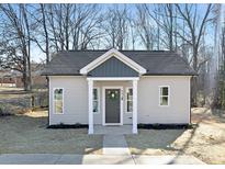 Charming home featuring neutral siding, a welcoming covered entryway, and a well-manicured lawn at 606 S 10Th St, Bessemer City, NC 28016