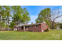Charming brick home with a well-manicured lawn and mature trees, creating a welcoming curb appeal at 101 Stoneybrook Dr, York, SC 29745