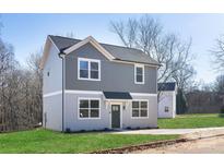 Charming two-story home with gray and blue siding, complemented by a neatly manicured lawn at 103 Webb St, Mount Holly, NC 28120