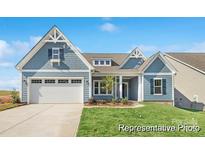 Charming craftsman-style home featuring a spacious two-car garage and manicured front yard at 1303 Links Crossing Dr # 219, Monroe, NC 28112