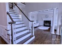 Bright foyer with a stairway and a view of the living room's fireplace at 143 S Gibbs Rd, Mooresville, NC 28117
