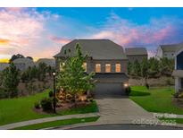 Charming two-story brick home with a well-manicured lawn and attached two-car garage at 17712 Yarwill Ct, Charlotte, NC 28278