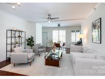 Bright living room with white walls, recessed lighting, and hardwood floors at 300 W 5Th St # 136, Charlotte, NC 28202