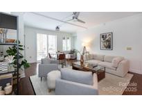 Bright living room featuring stylish furnishings, hardwood floors, and plenty of natural light at 300 W 5Th St # 136, Charlotte, NC 28202