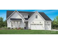 Charming white farmhouse featuring vertical siding, black roof, and a spacious two-car garage at 5300 Mint Harbor Way # 0286, Charlotte, NC 28269