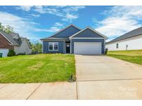 Charming single-story home featuring a two-car garage and well-maintained lawn at 544 Church St, Locust, NC 28097