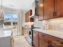 Bright kitchen featuring wood cabinets, white countertops and stainless steel appliances at 5727 Castlerea Dr, Charlotte, NC 28217