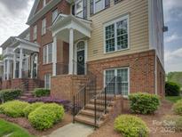 Brick and siding townhome featuring an inviting entrance, landscaped yard, and classic architectural details at 668 Sixth Baxter Xing, Fort Mill, SC 29708