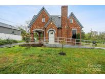 Charming brick home featuring a ramp to the front door and a well-manicured lawn at 115 12Th Sw St, Hickory, NC 28602