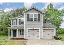 Charming two-story home with attached two-car garage and manicured front yard, great curb appeal at 1213 Salvadore Ct, Gastonia, NC 28052