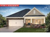 Charming single-story home featuring stone accents, a two-car garage, and a covered front porch at 1324 Secrest Commons Dr, Monroe, NC 28112