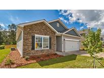 Charming home featuring stone accents, a two-car garage, and professional landscaping at 1328 Secrest Commons Dr, Monroe, NC 28112