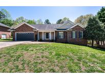 Charming brick home with a well-manicured lawn and attached garage, offering curb appeal and convenience at 2426 36Th Ne Ave, Hickory, NC 28601