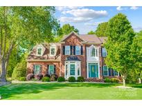 Beautiful two-story brick home with a well-manicured lawn and lush landscaping at 62 Pond View Ln, Fort Mill, SC 29715