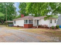 Charming single-story home featuring a welcoming front porch, brick accents, and a well-maintained lawn at 1116 Montgomery Ave, Albemarle, NC 28001