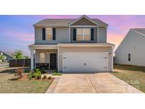 Charming two-story home featuring a two-car garage, neutral siding, and well-maintained landscaping at 1124 Culver Spring Way, Charlotte, NC 28215