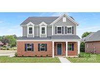 Charming two-story home with brick and gray siding, complemented by a well-manicured lawn at 1701 30Th Avenue Ne Ct, Hickory, NC 28601