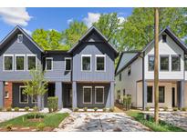 Charming new construction showing a two-story home with a manicured lawn and neutral-colored siding at 2008 St John St, Charlotte, NC 28216