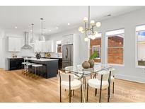 Bright, open-concept kitchen and dining area featuring modern finishes and stainless steel appliances at 2008 St John St, Charlotte, NC 28216