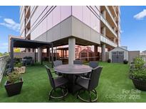 Modern building with rooftop patio, shed, pergola, barbecue grill, and outdoor furniture at 315 Arlington Ave # 506 & 507, Charlotte, NC 28203