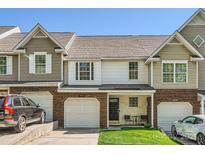 Charming townhome featuring a brick facade, attached garage, and a small front lawn at 3420 Caldwell Ridge Pkwy, Charlotte, NC 28213