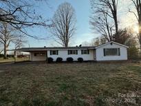 Charming one-story home with a covered parking, green shutters, and manicured bushes at 539 Jennings Rd, Statesville, NC 28625