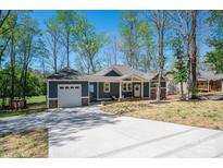 Charming single-story home with a garage and a concrete driveway and beautifully landscaped front yard at 912 Westside Dr, Newton, NC 28658