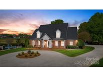 Charming brick home boasts a manicured front yard, circular driveway, and inviting curb appeal at 105 Snead Ct, Salisbury, NC 28144