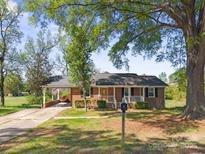 Charming brick ranch with a cozy front porch and convenient carport at 1337 Eastside Ave, Albemarle, NC 28001