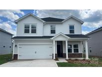 Charming two-story home featuring a two-car garage, a covered entryway, and a well-manicured lawn at 142 Aberdeen Dr, Salisbury, NC 28144