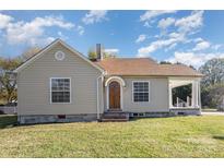 Charming single-story home featuring a cozy front porch, traditional windows and a well-maintained lawn at 2001 S Main St, Kannapolis, NC 28081
