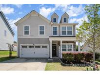 Beautiful two-story home with a cozy front porch, attached garage, and lovely curb appeal at 2220 Atwell Glen Ln, Pineville, NC 28134