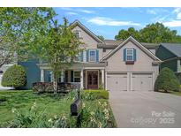 Charming home featuring a landscaped front yard, a two-car garage and a welcoming porch at 3060 Drummond Ave, Indian Land, SC 29707