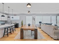 Spacious living area with an open floor plan that showcases the modern kitchen and comfortable seating at 310 Wesley Heights Way, Charlotte, NC 28208