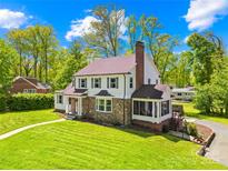 Charming two-story home with stone accents, complemented by lush green lawn and mature trees at 621 N 9Th St, Albemarle, NC 28001