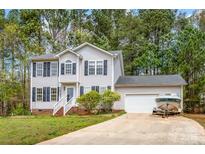 Charming two-story home with gray siding, black shutters, landscaped yard, and attached garage at 7536 Bimini Ct, Sherrills Ford, NC 28673