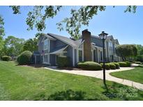 Charming two-story home with a well-manicured lawn, complemented by lush greenery and a sidewalk leading to the entrance at 8257 Legare Ct, Charlotte, NC 28210