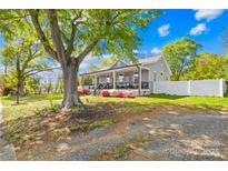 Beautiful exterior view of the house featuring a large tree providing shade and curb appeal at 911 Earl St, Shelby, NC 28150