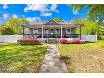 Charming home with a spacious front porch and lush landscaping, creating a welcoming curb appeal at 911 Earl St, Shelby, NC 28150