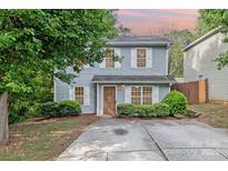 Charming two-story home with light-blue siding, white shutters, well-maintained landscaping, and a concrete driveway at 248 Pangle Dr, Charlotte, NC 28217