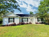 Charming single-story home with a well-maintained lawn, mature trees, and classic black shutters at 252 S Potter Rd, Lancaster, SC 29720