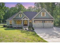 Charming home featuring a well-manicured lawn and a three-car garage at 2586 Lee Lawing Rd, Lincolnton, NC 28092