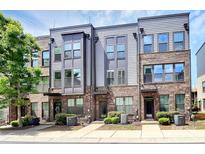 Exterior view of modern townhomes with brick and gray siding, showcasing their contemporary design at 510 Music Hall Way, Charlotte, NC 28203
