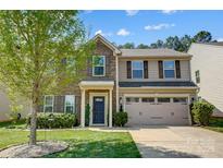 Charming two-story home featuring a stone and siding exterior, well-maintained landscaping, and an attached two-car garage at 5628 Selkirkshire Rd, Charlotte, NC 28278