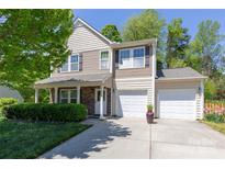 Charming two-story home with a well-manicured lawn, a two-car garage, and stone accents at 602 Black Maple Dr, Kannapolis, NC 28081