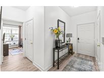 Inviting foyer featuring a decorative table, mirror, and neutral decor at 12357 Copper Mountain Blvd, Charlotte, NC 28277